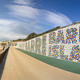 Illustration for article titled This Typographic Climbing Wall Stretches the Length of a Beach